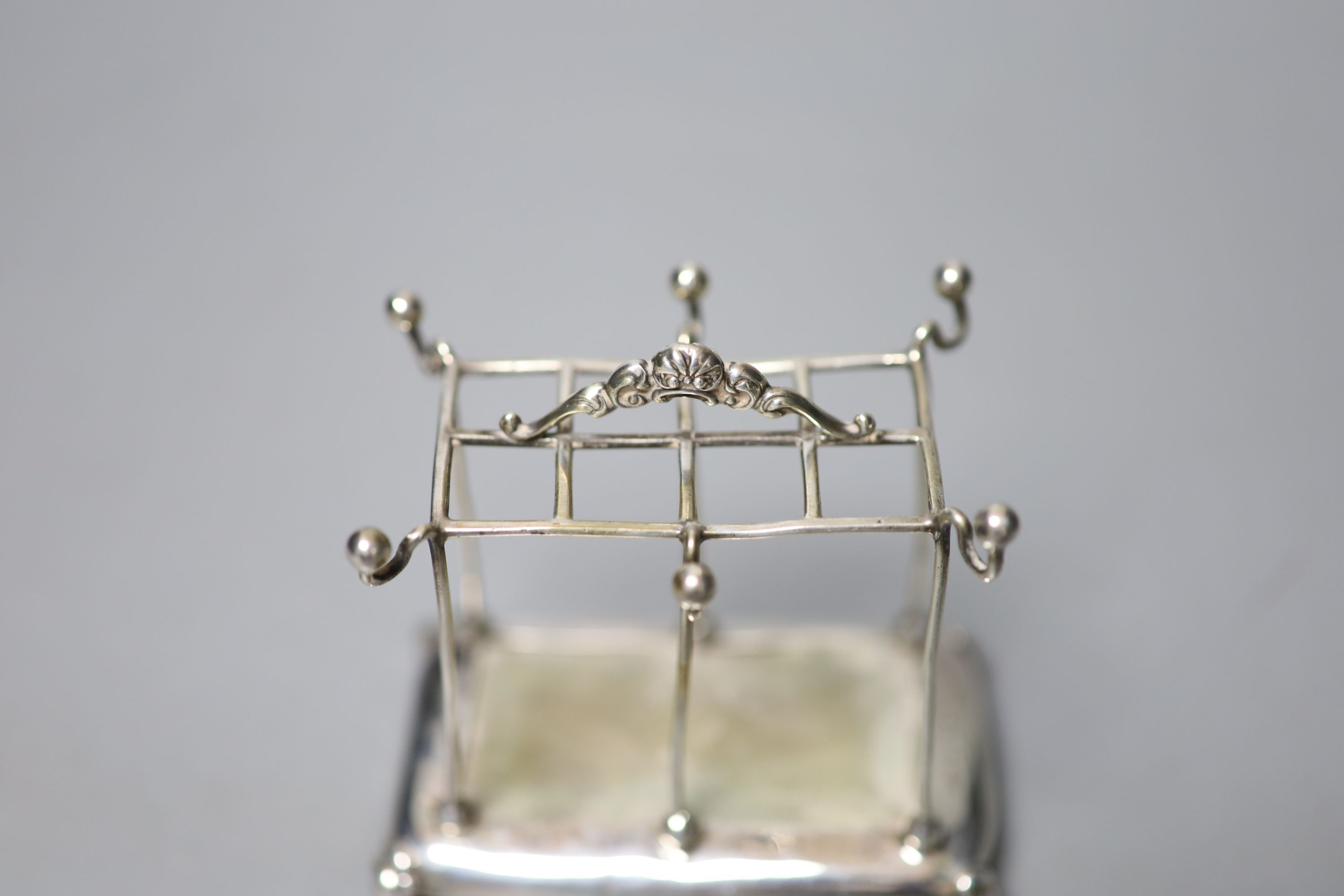 An Edwardian silver mounted hat pin? and ring stand, Mappin Bros. Birmingham, 1909, height 8.1cm.